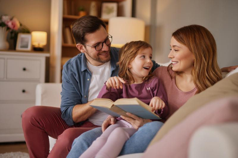 Family Reading a Book in Living Room